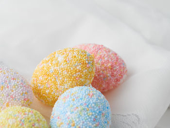 Close-up of multi colored candies on white background