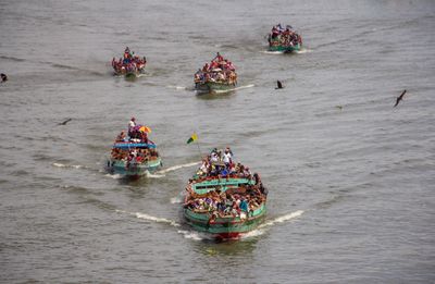 High angle view of people kayaking in sea