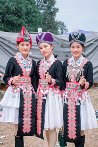 Portrait of happy girl standing on traditional clothing