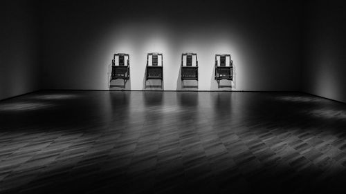 Empty table and chairs on floor against wall at home