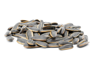 High angle view of roasted coffee beans on white background