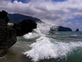 Scenic view of sea against cloudy sky