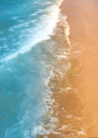 High angle view of waves rushing towards shore