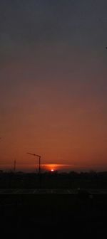 Scenic view of silhouette road against sky at sunset