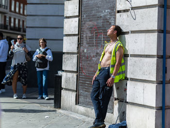 Full length of man standing against building in city