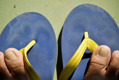 Low section of man with flip-flop