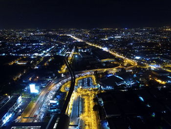 Aerial view of illuminated city against sky at night