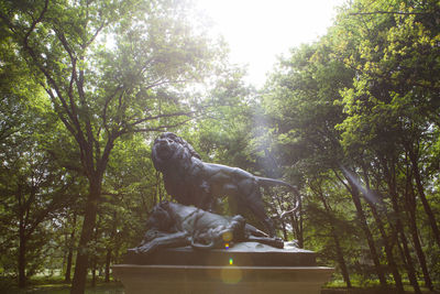 Low angle view of statue against trees