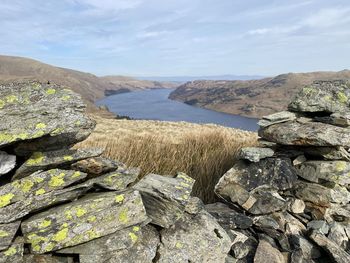 Rocks in sea against sky