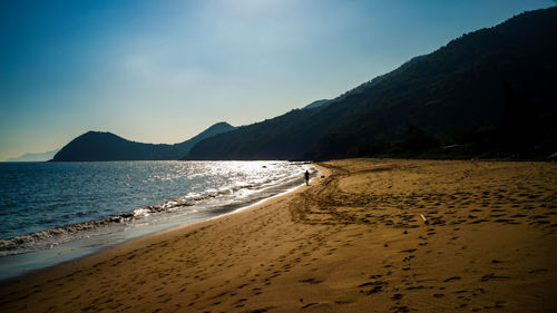 Scenic view of beach against sky during sunset