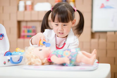 Cute girl sitting on table