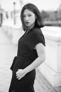 Portrait of young woman standing outdoors