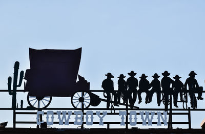 Rear view of silhouette people standing against clear sky