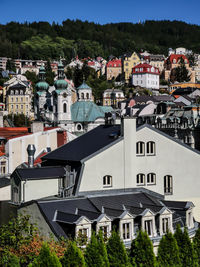 Buildings in town against sky