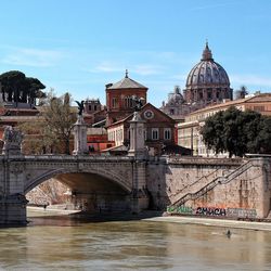 Bridge over river with buildings in background