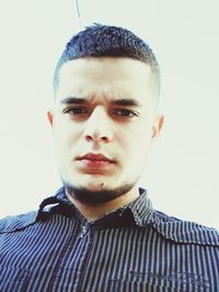 Close-up portrait of young man against white background