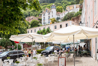 People on street by buildings in city