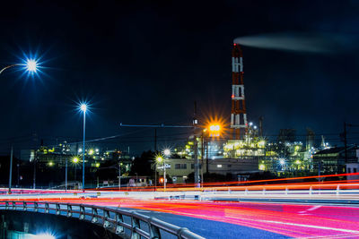 Illuminated bridge against sky at night
