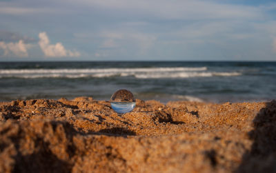 Rocks on beach against sky