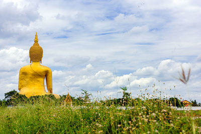 Gold buddha statue against sky