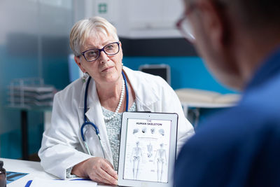 Doctor talking with patient in clinic