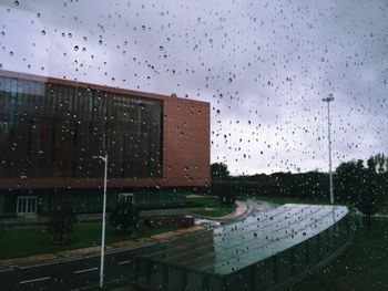 Building seen through wet glass window