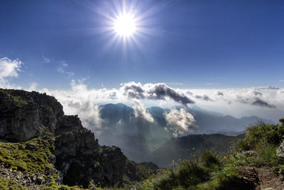 Low angle view of mountains against sky on sunny day