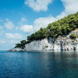 Scenic view of calm sea against cloudy sky