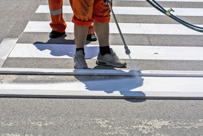 Low section of people walking on road