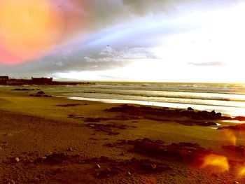 Scenic view of beach against sky during sunset