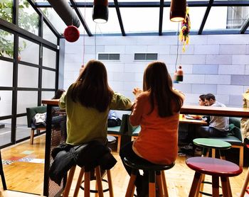 Rear view of two people on table