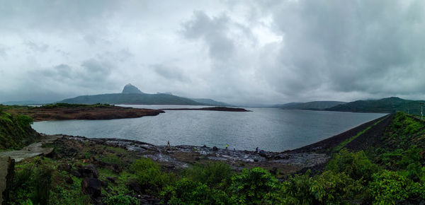 Panoramic view of bay against sky