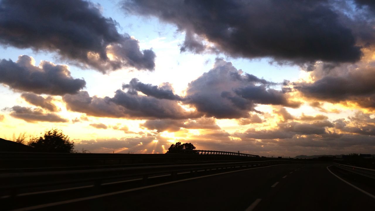 sky, transportation, cloud - sky, sunset, the way forward, road, cloudy, diminishing perspective, road marking, dramatic sky, vanishing point, cloud, silhouette, overcast, weather, scenics, nature, tranquility, tranquil scene, storm cloud