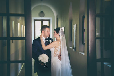 Couple standing in corridor of building