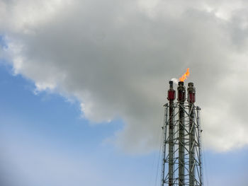 Low angle view of communications tower against sky