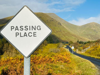 Low angle view of road sign against sky