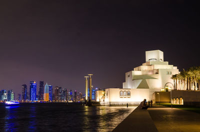 Illuminated museum of islamic art against sky at night