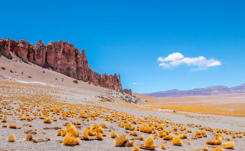 Scenic view of rocky mountains against blue sky