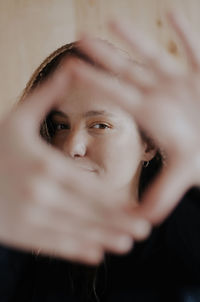 Portrait of beautiful woman making finger frames