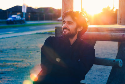 Portrait of young man sitting outdoors