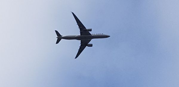 Low angle view of airplane against clear sky