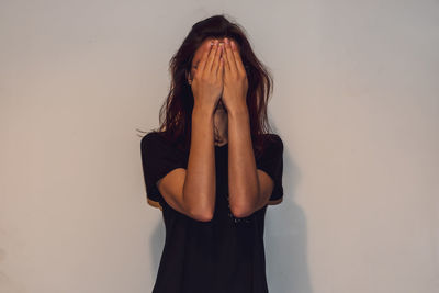 Beautiful woman standing against wall