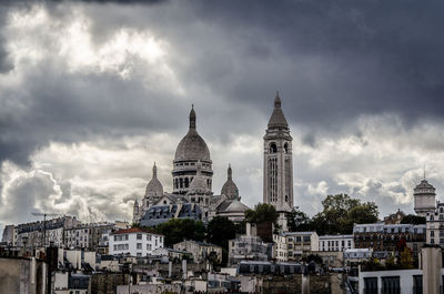 View of cathedral in city against cloudy sky