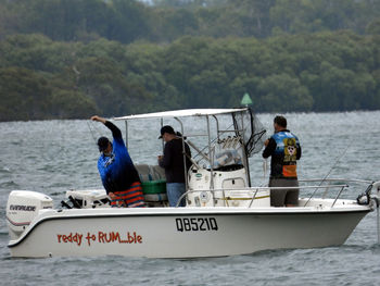 People standing on boat in sea