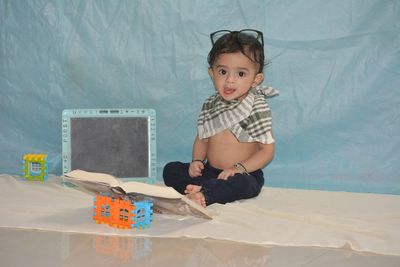 Portrait of cute girl sitting on table