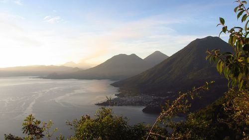 Scenic view of lake and mountains against sky