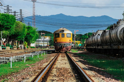 Train on railroad tracks against sky