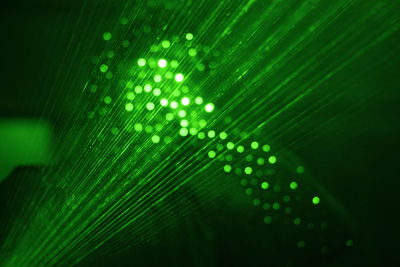 Defocused image of illuminated lights against black background