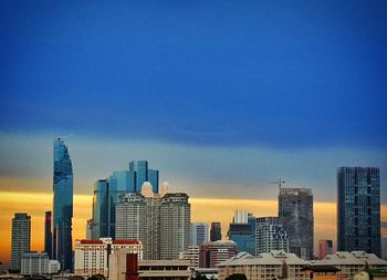 Skyscrapers in city at dusk