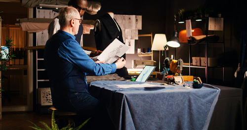 Side view of man working at home